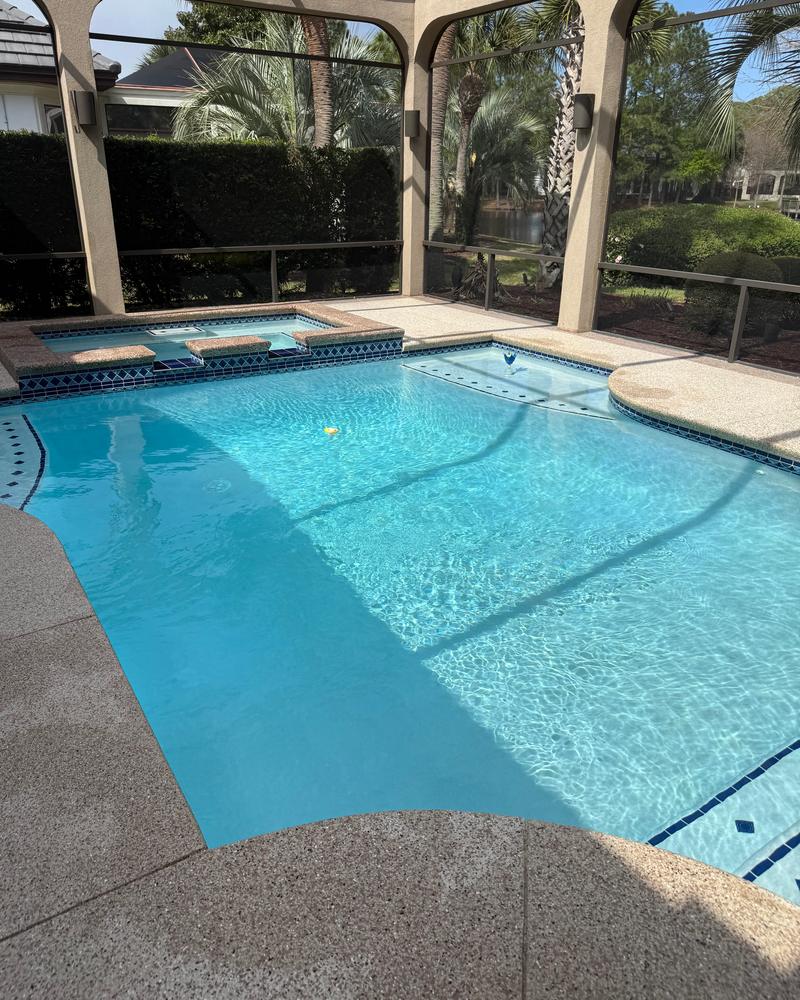 Screened lanai pool and spa with blue tile and clear water